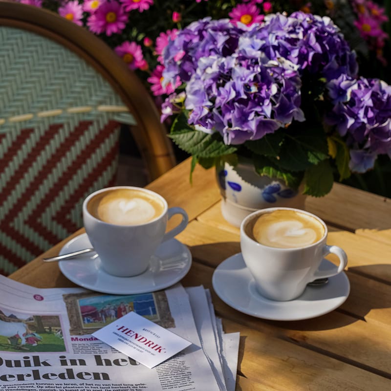 Two cappuccinos and the newspaper on the terrace