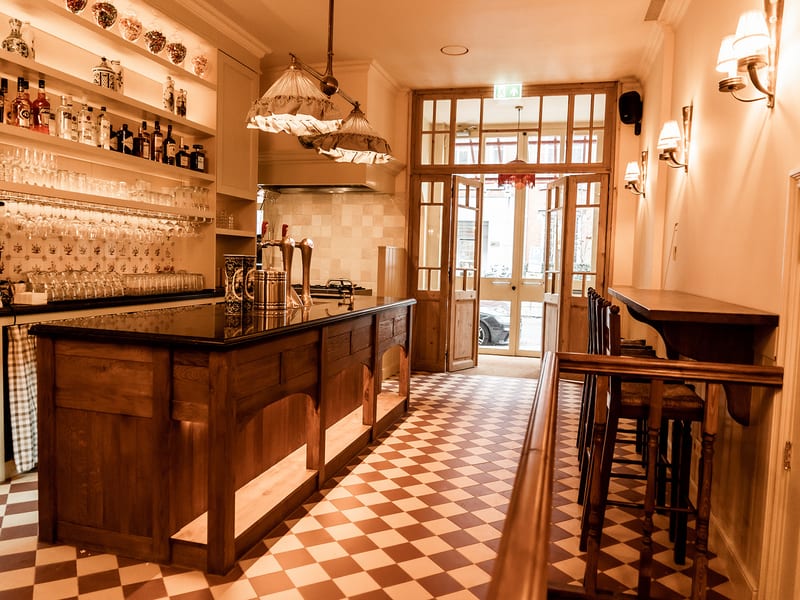 The wooden bar with its red and white chequered floor