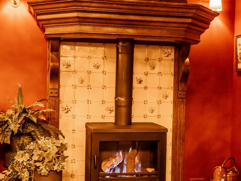 The fireplace with the wood stove in the red room