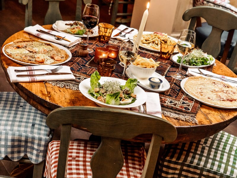 A table laid with pancakes and salads