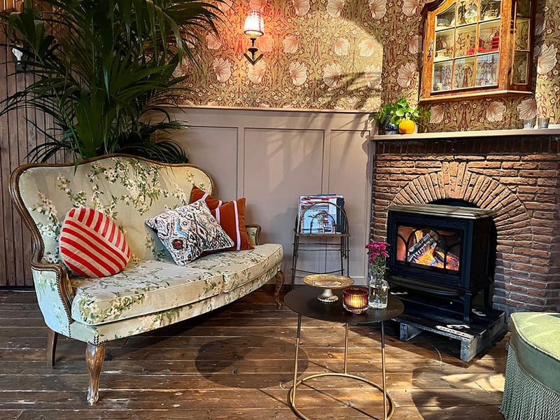 The sofa by the wood stove in the front room